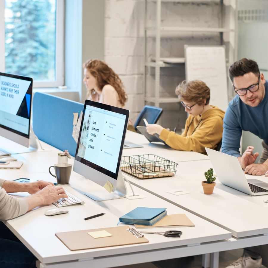 Employees working at computers across a modern office