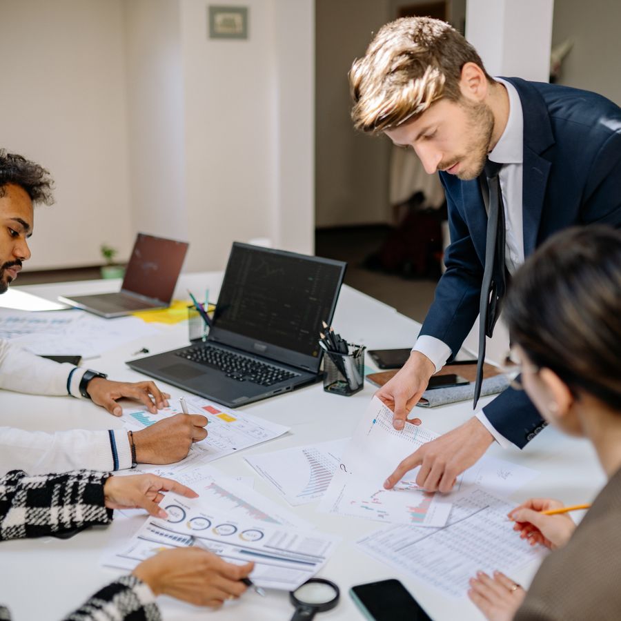 A finance team analyzing charts and reports